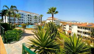 a view of a resort with palm trees and buildings at DiCaprio - Sunset Ritual incl I by MovieStar Holidays in Mijas Costa