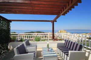 a group of chairs and a table on a patio at Apartments Kurilj in Makarska