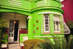 a green house with a bird cage on it at POA Eco Hostel in Porto Alegre