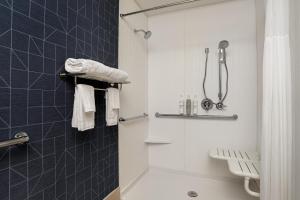 a bathroom with a shower and a toilet and towels at Spark by Hilton West Coxsackie in West Coxsackie +17 photos