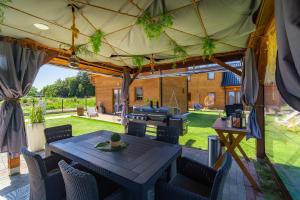 a patio with a table and chairs under a tent at Amara Houses in Rewal