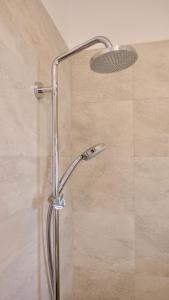 a shower with a shower head in a bathroom at Apartments Villa Agatha in Sveti Filip i Jakov