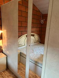 a small room with a bed in a brick wall at Lavanda CITY in Sevan