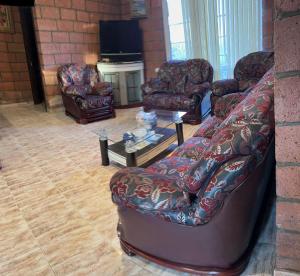 a living room with a couch and chairs and a table at Lavanda CITY in Sevan