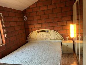 a bed in a room with a brick wall at Lavanda CITY in Sevan +7 photos