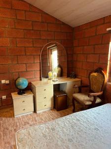 a bedroom with a bed and a desk and a mirror at Lavanda CITY in Sevan