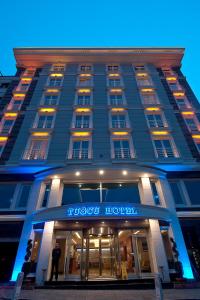 a hotel building with a sign on the front of it at Tugcu Hotel Select in Bursa