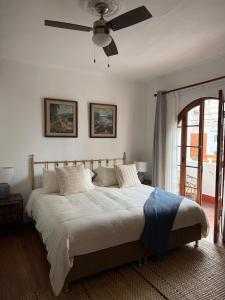 a bedroom with a large bed with a ceiling fan at Casa La residencia Perú in Lima