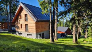 a house with solar panels on the roof at Aparthaus PINIA - Martinské hole in Demanovska Dolina