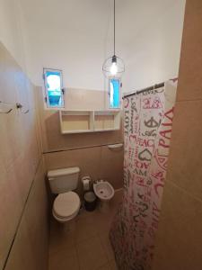 a small bathroom with a toilet and a sink at Rincon de Golu - Villa General Belgrano in Villa General Belgrano