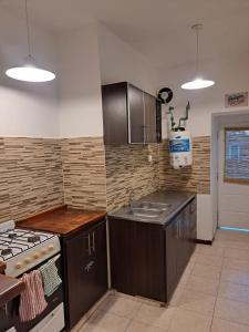 a kitchen with wooden cabinets and a sink and a stove at Rincon de Golu - Villa General Belgrano in Villa General Belgrano +15 photos