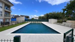a swimming pool in the backyard of a house at Recuncho Peña in O Porto de Espasante