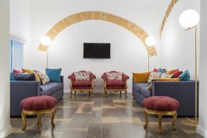 a living room with couches and chairs and a tv at Viacolvento in Marsala