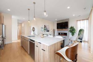 a kitchen with a large island with white counter tops at New 3Bed 3Bath Condo with Parking by United Center in Chicago
