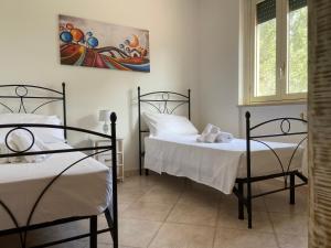 Postel nebo postele na pokoji v ubytování Villa Laurus