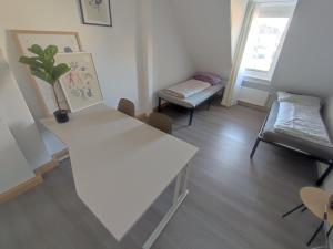 a living room with a white table and a chair at Bright and Spacious Apartment in Wiesbaden City Center in Wiesbaden +68 photos