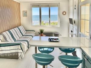 a living room with a couch and a table at Le Pokerdas 2 - lesparisnormands in Villers-sur-Mer