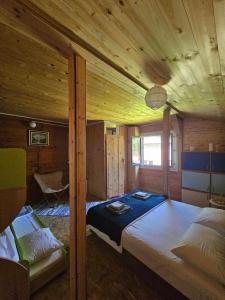 a bedroom with a large bed in a wooden room at Sunrise in Ulcinj