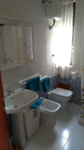 a bathroom with a sink and a toilet at Casa vacanze " il muretto" in Gallipoli +14 photos