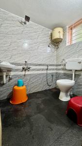 a bathroom with a toilet and a sink at Ratna Residency in Udupi