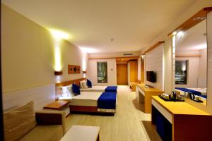 a hotel room with two beds and a couch at Jasmin Beach Hotel in Gümbet