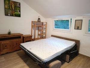 a small bedroom with a bed and a window at studio cosy en pleine forêt in Anduze
