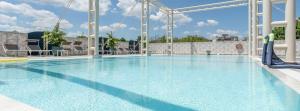 a swimming pool at a resort with a water slide at Hotel Palm Beach B&B SEA VIEW in Rimini