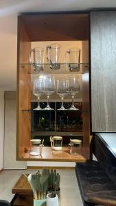 a shelf with wine glasses in a kitchen at Mirador pueblito Paisa-Tipo loft in Medellín