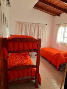 a bedroom with two bunk beds and a window at Rincon de Golu - Villa General Belgrano in Villa General Belgrano