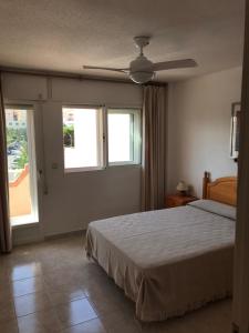 a bedroom with a bed and a ceiling fan at DUPLEX 3 DORMITORIOS en LA MANGA in San Javier +17 photos