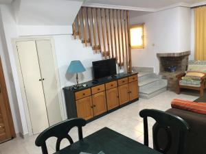 a living room with a television and a couch at DUPLEX 3 DORMITORIOS en LA MANGA in San Javier