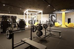 a gym with dumbbells and other equipment in a room at Paraíso Altântico in Machico