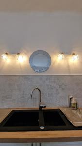 a kitchen counter with a sink and a sink at Apartment Joie de Vivre in Béziers