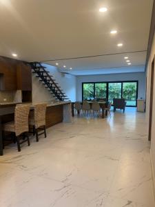 a large living room with a table and chairs at Beautiful home in El Tigre golf course Nuevo Vallarta! in Nuevo Vallarta  +5 photos