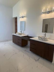 a bathroom with two sinks and a mirror at Beautiful home in El Tigre golf course Nuevo Vallarta! in Nuevo Vallarta 