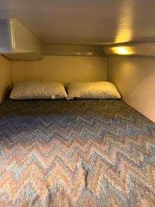 a small bedroom with two beds in a trailer at Location in Antibes