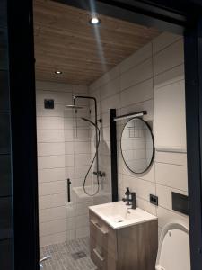 a bathroom with a sink and a shower and a mirror at 2 cabins surrounded by beautiful nature in Stryn