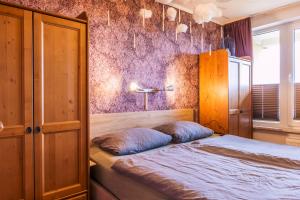 a bedroom with a bed and a purple wall at Muggel willkommen - Harz-Auszeit im Zauberquartier in Braunlage