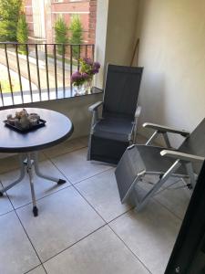 a balcony with a table and a chair and a table at Studio De Kevie in Tongeren