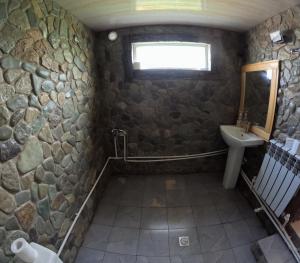 a bathroom with a stone wall and a sink at Yerivar in Semyonovka +33 photos