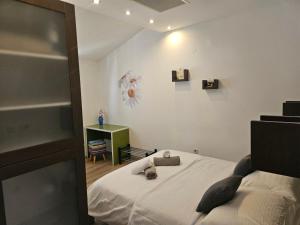 a bedroom with a bed and a table with a chair at Apartmani Marinović in Podgora