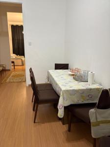 a dining room with a table with a table cloth on it at Casarão Maracanã in Rio de Janeiro +20 photos