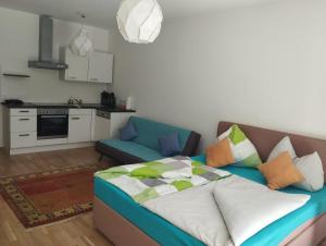 a living room with a bed and a kitchen at BLR Apart in Graz