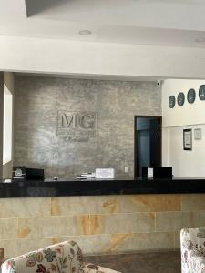 a lobby with a mrc sign on a wall at Suite Casa Grande in Rionegro +13 photos