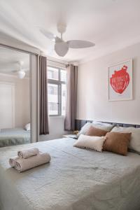 a bedroom with a large bed with a ceiling fan at Casa Serena in Brasilia