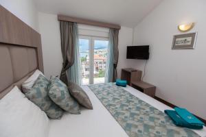 a hotel room with a bed and a window at Anikol Apartments in Selce +134 photos