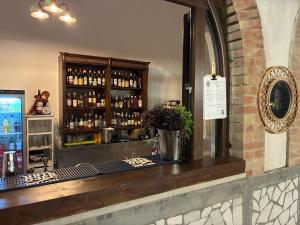 a bar in a restaurant with a shelf of alcohol at Bosco Elda in San Giovanni Rotondo