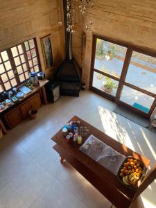 an overhead view of a living room with a table and a stove at InnFloripa - Pousada no Campeche 7 min do Aeroporto in Florianópolis