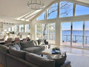 a large living room with a large couch and a kitchen at Soul Beach Lake House in Chapin