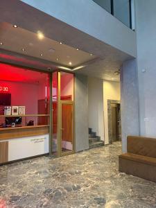 a lobby with a couch in a building at Studio Crnjanski in Jagodina +8 photos